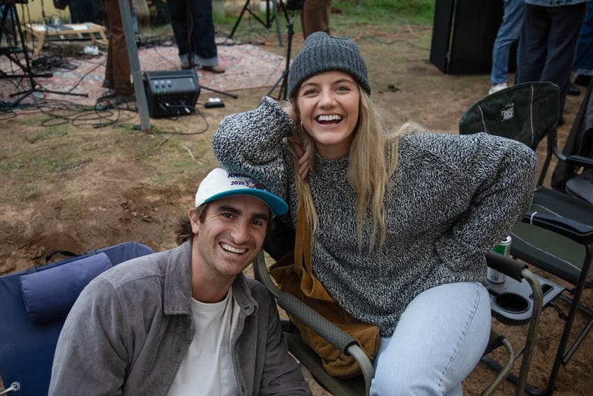 Two guests laughing in camp chairs