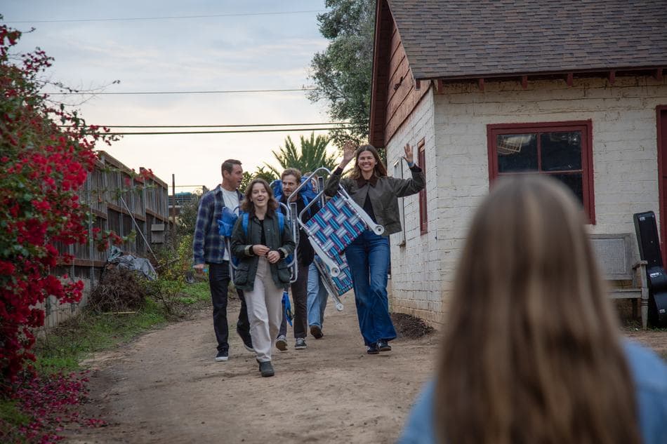 Guests walking in with camp chairs