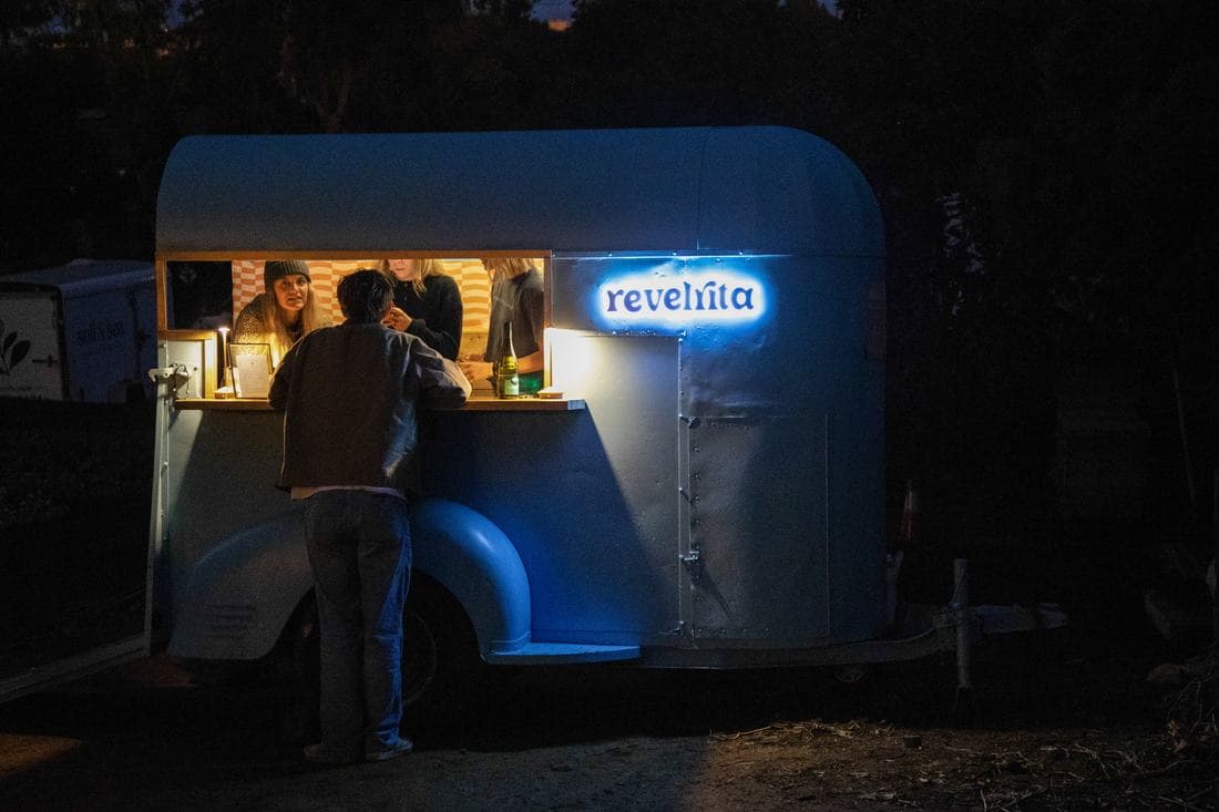 The cart lit up at night with guests at the window