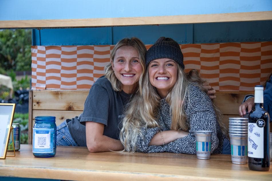 Two guests leaning into the bar window