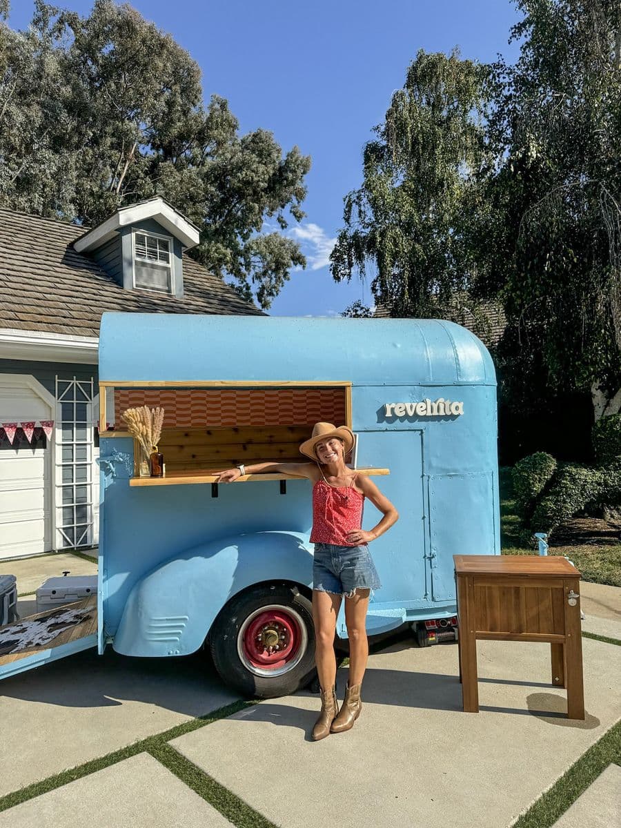 Helen standing beside the Revelrita bar cart