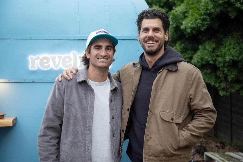 Two guests in front of the lit revelrita sign