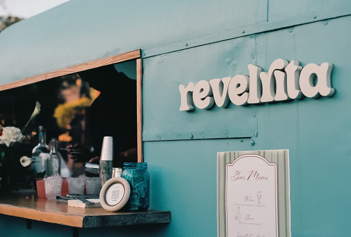 The revelrita sign beside a wedding bar menu